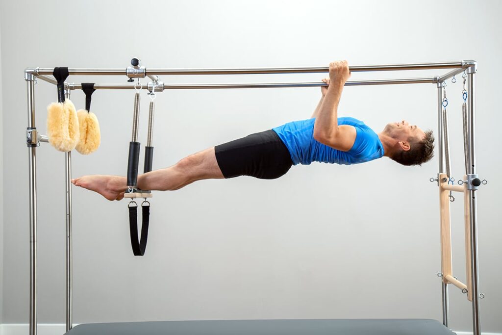 Person exercising on CenterLine Cadillac Pilates equipment.