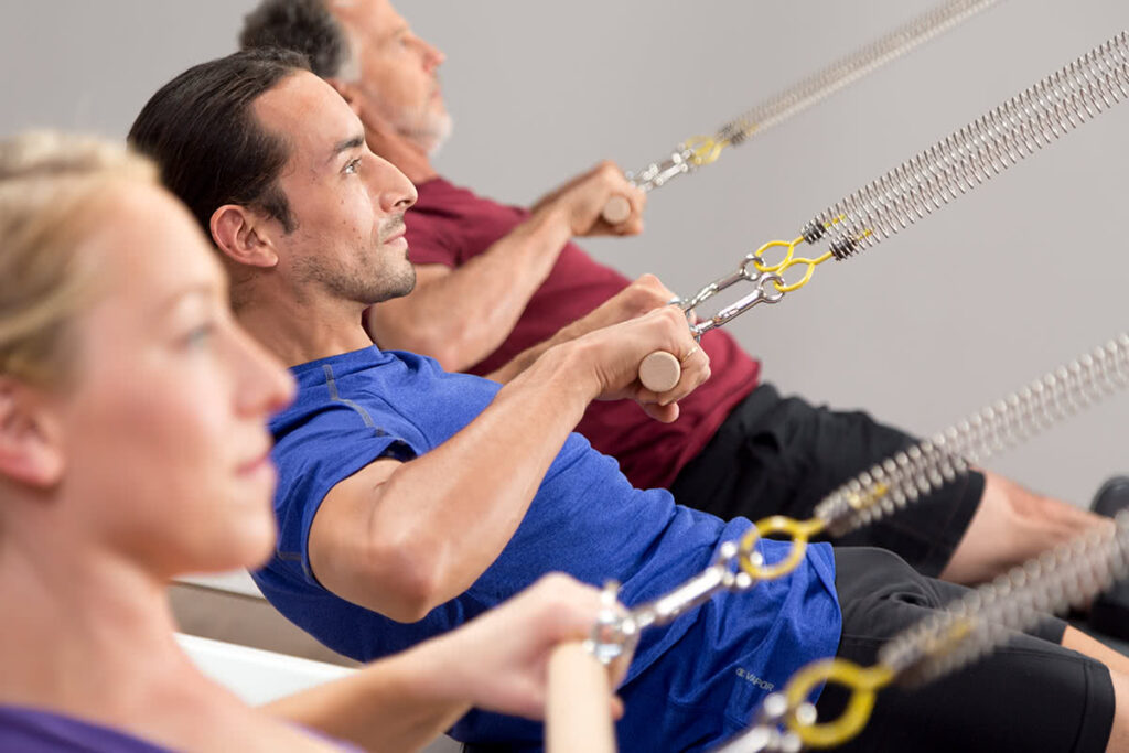 Pilates enthusiasts using the Allegro Tower of Power for exercise.