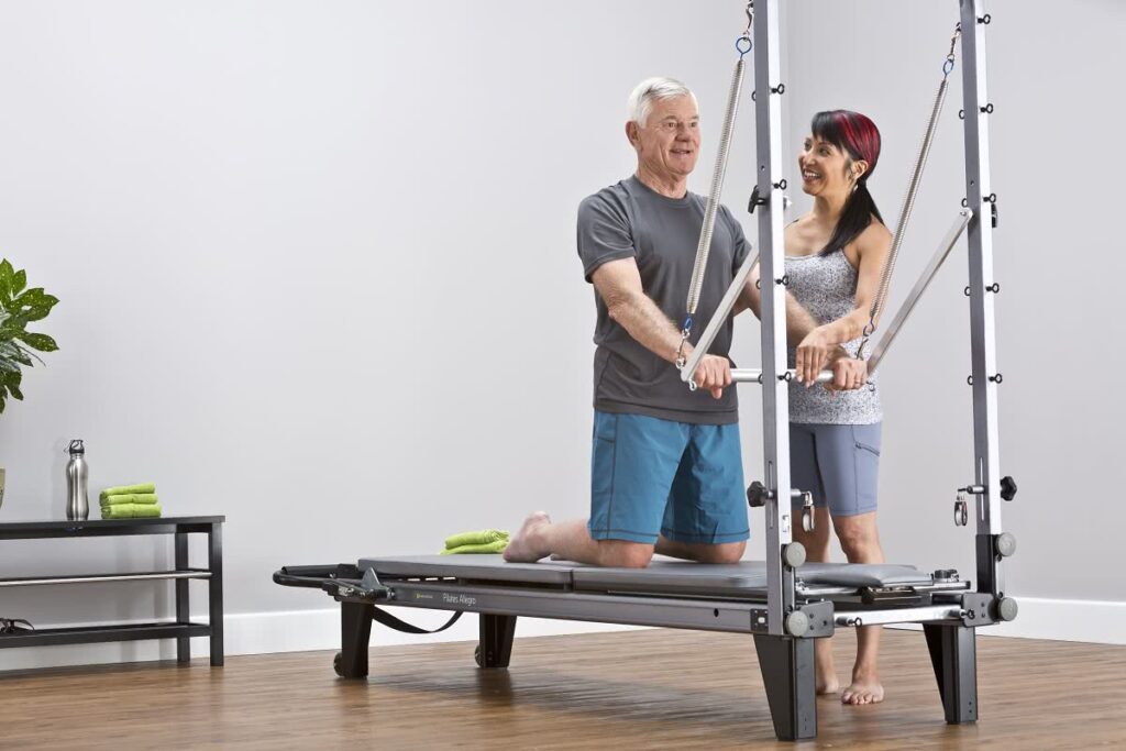 Allegro Tower of Power Pilates equipment in use