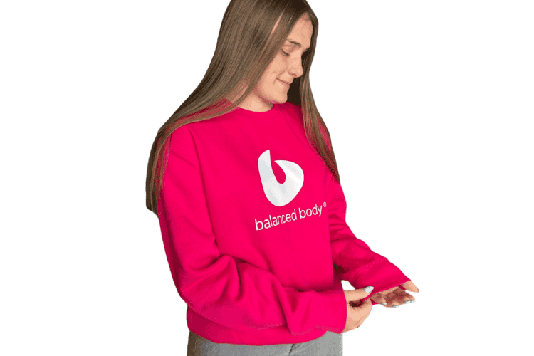 Woman wearing Balanced Body crewneck sweatshirt