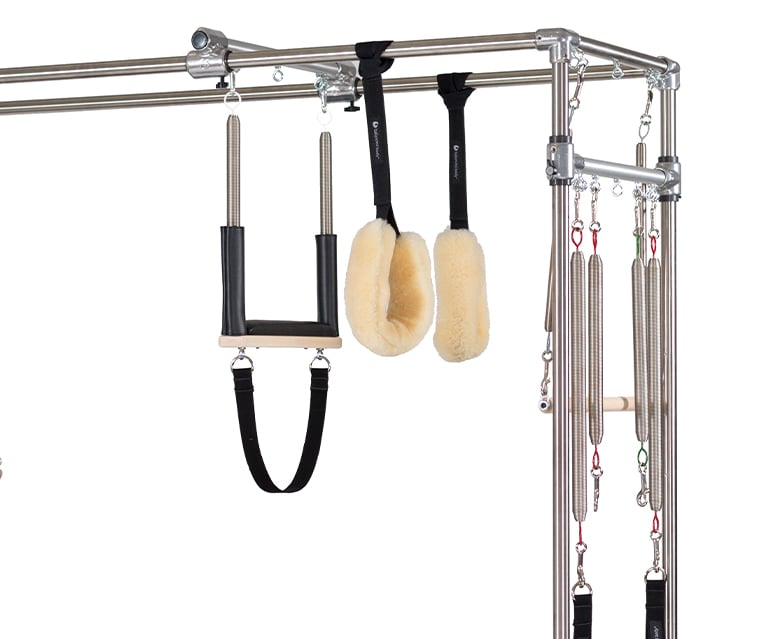 Pilates PTB system with adjustable wood bars, straps, and handles