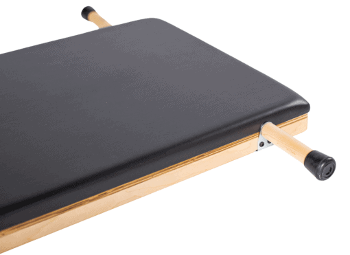 Elevated Design Pilates Equipment Feature Elevated Pilates product with durable black upholstery and ergonomic grips.