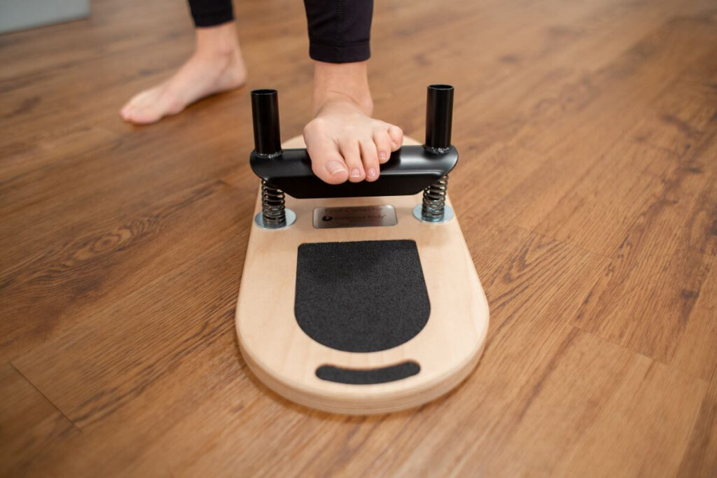 Balanced Body Foot Corrector in use on wooden floor