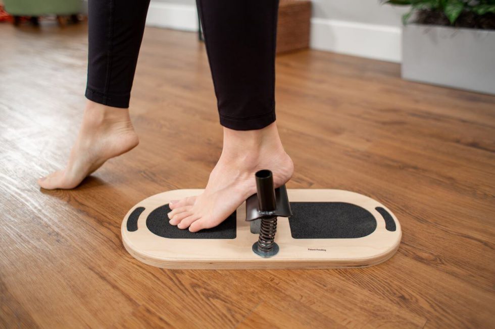 Person using Balanced Body Foot Corrector for foot exercise
