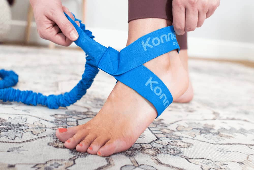 Konnections Band secured around foot for Pilates exercises.