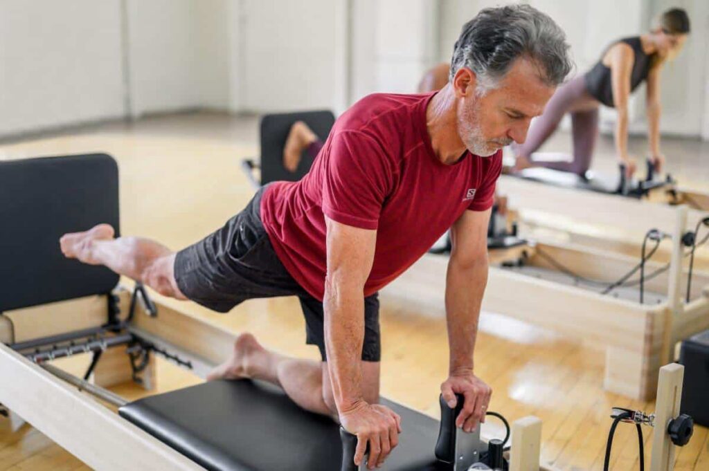 Pilates instructor using Studio Reformer with Jumpboard.