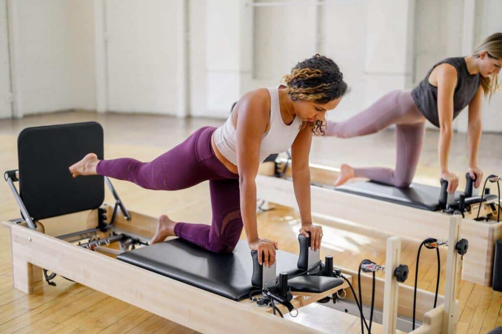 Pilates exercise with Studio Reformer and Jumpboard in a studio.