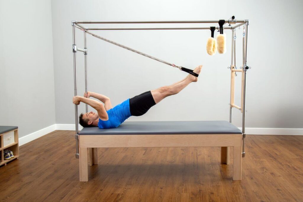Person using Balanced Body Trapeze Signature Springs for Pilates.