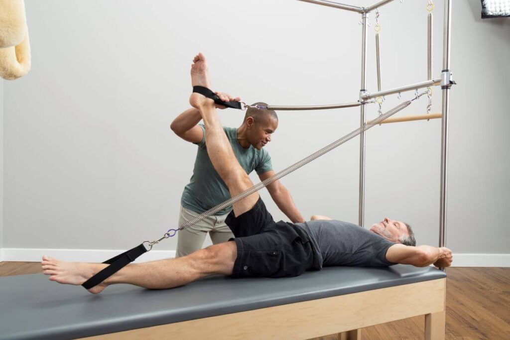 Instructor assisting client using Trapeze Signature Springs.