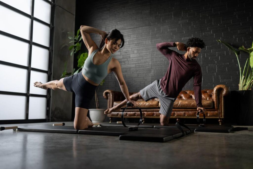 People using Balanced Body Spring Circle for Pilates exercises.