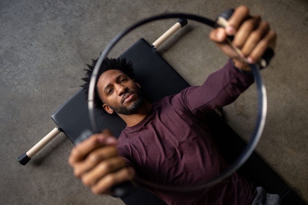 Person using Balanced Body Spring Circle for Pilates exercise.